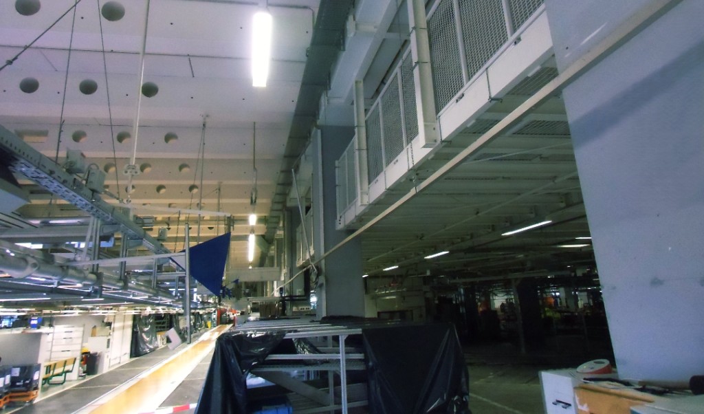 Modern manufacturing hall with production lines and industrial lighting