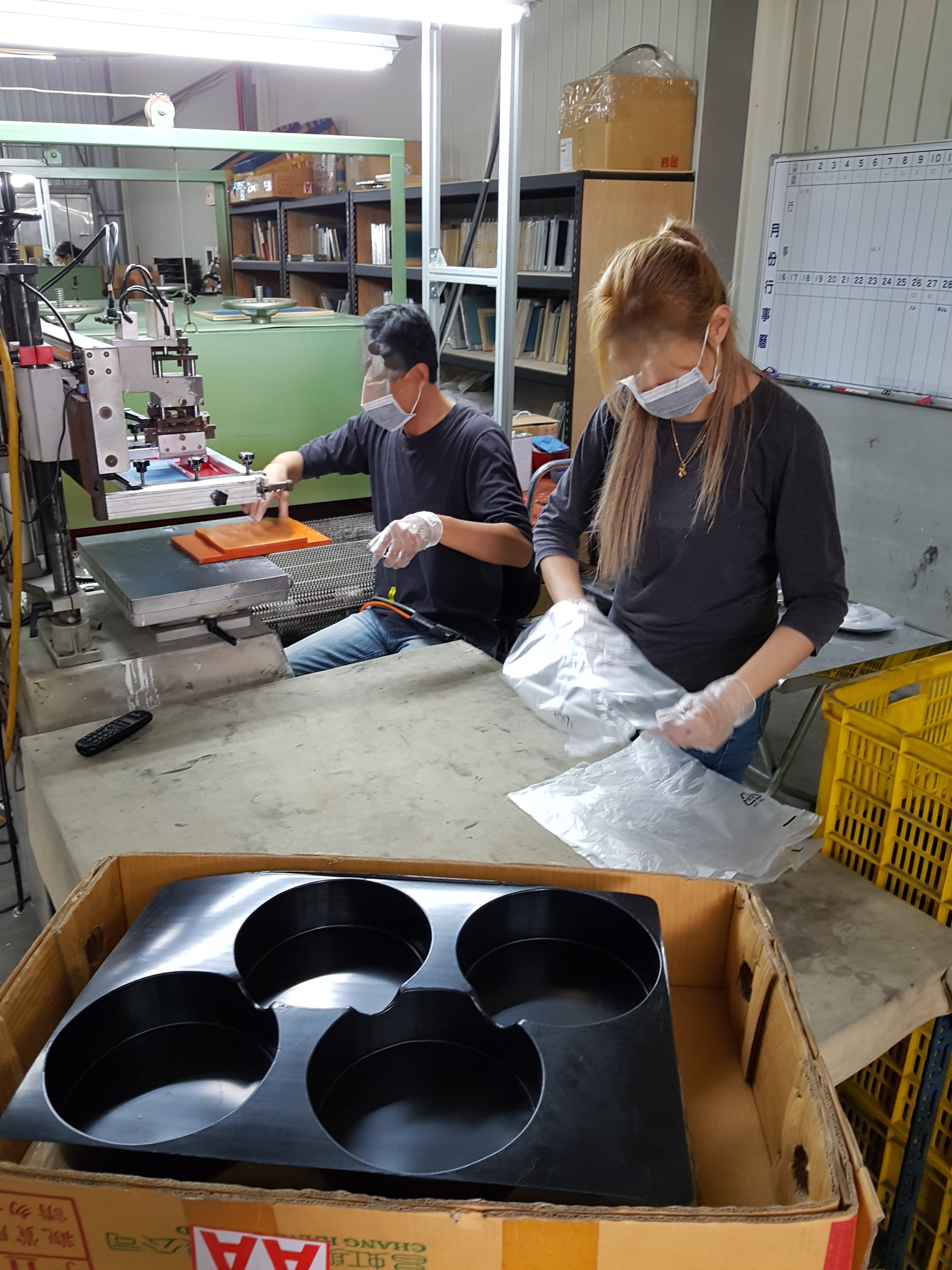 Shop-floor production and packaging work in an international manufacturing environment